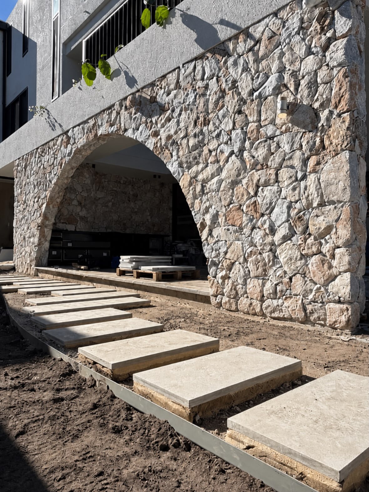 Hand-laid stone archway framing a stepped entrance