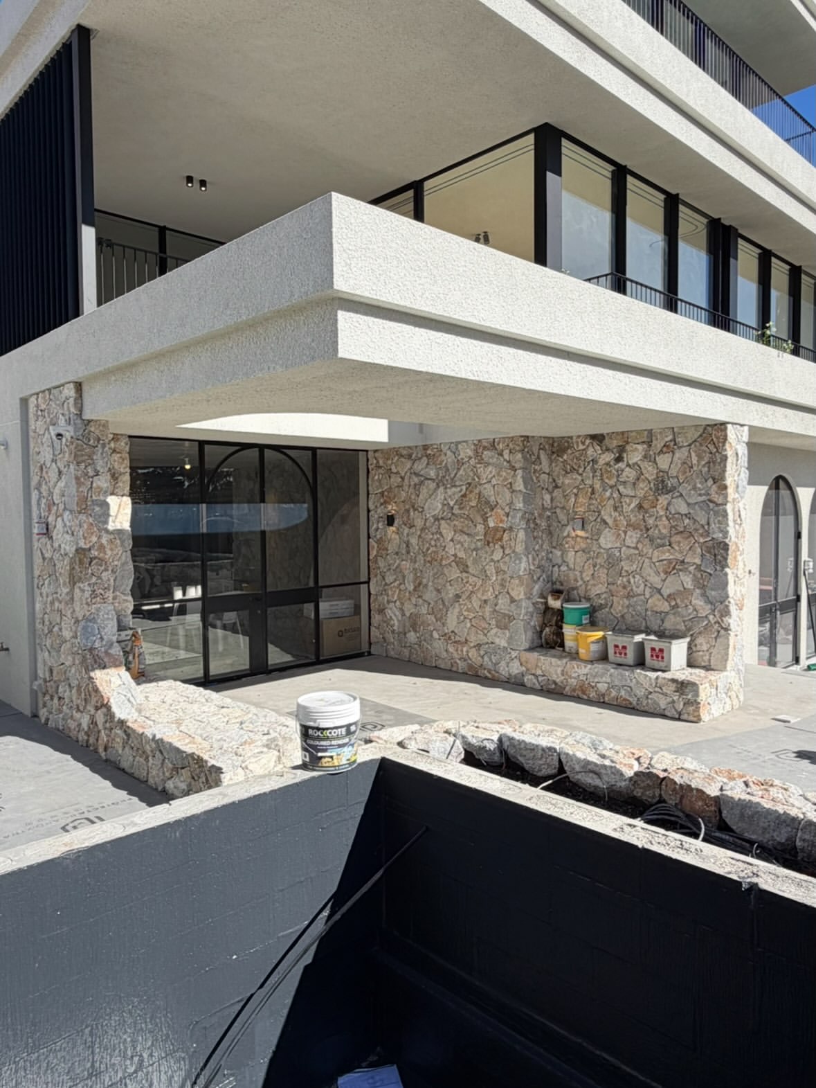 Coastal Stoneworks exterior stone cladding beneath white balconies
